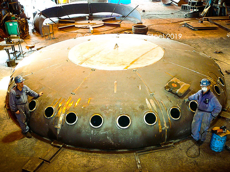 Flued holes being cut on a multi segmented tank head